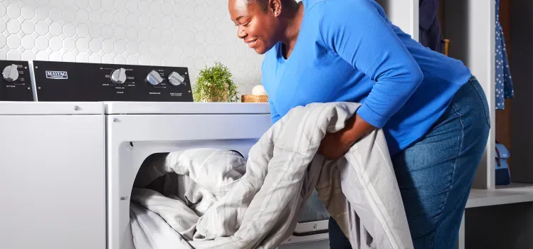 woman-removing-comforter-from-maytag-commercial-dryer-MEDP586KW